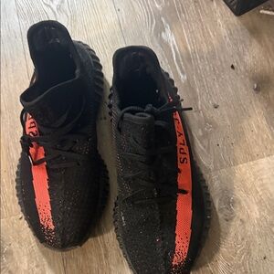 Yeezy 350s red and black with letters on the side
